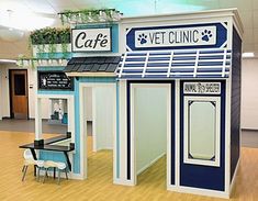 a dog grooming shop with blue and white painted on the front, doors open to let in some fresh air