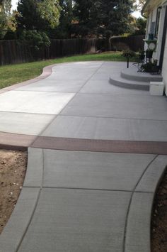 a concrete walkway in front of a house