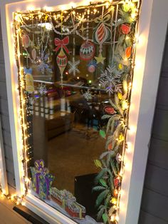 a window with christmas decorations and lights on it