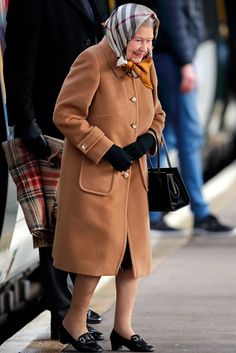 an older woman in a brown coat and black shoes