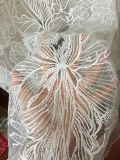 white sheer lace fabric with flowers on it