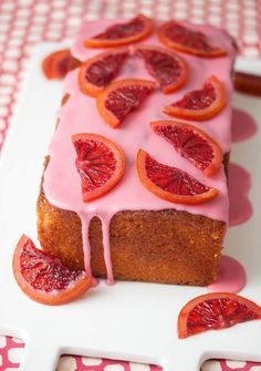 a cake with blood oranges and icing on it