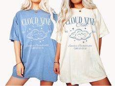 two women in matching tshirts standing next to each other with clouds and stars on them