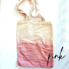 a pink and white tote bag with the word pink on it's side