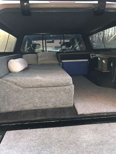 the back end of a truck with an open bed and couch in it's trunk