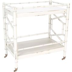 a white bamboo shelf with two shelves on each side