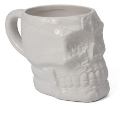 a white mug with a skull design on it