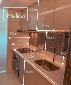 a kitchen with an oven, sink and refrigerator labeled in different measurements for the space