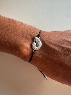 A minimal Sea Shell bracelet that is made from a unique Cowrie Shell from brass and is passed through an adjustable black cord, that creates the perfect color combination between these materials. Choose between four different dimensions. You can wear them together as set or separetely. Find them only at Christina Christi Store. 👉 My Mens Bracelets Collection: https://etsy.me/2UunKla 👉 Express Shipping: https://etsy.me/3ikUnOM MATERIALS - Metal Sea Shell (Brass). - Balck Cord. DIMENSIONS - You Cowrie Shell Bracelet, Seashell Bracelet, Bracelets Collection, Mens Bracelets, Jewelry Mens, Seashell Jewelry, Bracelet Men, Shell Bracelet, Shell Jewelry