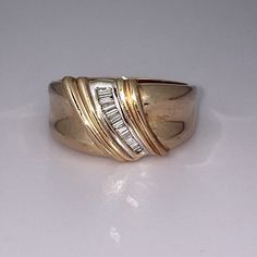 a gold ring with three diamonds on it