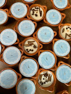 many blue and white plates with desserts in them sitting on a wooden table top