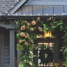 the front entrance to a building with wreaths and lights