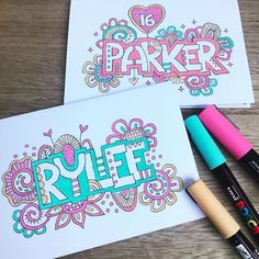 two coloring pages with markers and pens on the table