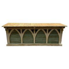 a wooden bench with an arched design on the top