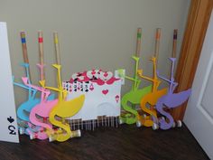 a group of colorful wooden toys sitting on top of a hard wood floor next to a door