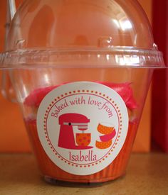 a plastic container filled with candy sitting on top of a table