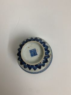 a small blue and white bowl sitting on top of a table