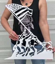 a woman holding up a cutout of an american flag