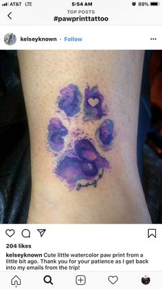 a purple paw print on the ankle with hearts and words written below it in cursive writing