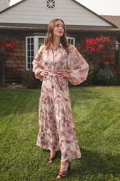 This floral chiffon maxi dress is sophisticated yet effortless with its high collar, button-up design paired with bishop sleeves, tiered skirt, and a slim matching sash. Crafted with a soft, airy fabric that drapes beautifully, this piece is a timeless addition to any wardrobe. Machine wash cold, gentle cycle, and hang dry. Feminine Daywear Dress With Blouson Sleeves, Spring Daywear Maxi Dress With Tiered Skirt, Tiered Skirt Maxi Dress For Daywear In Spring, Feminine Tiered Skirt Maxi Dress For Daywear, Feminine Tiered Maxi Dress For Daywear, Tiered Maxi Dress With Floral Print For Daywear, Floral Print Tiered Maxi Dress For Daywear, Daywear Floral Print Tiered Maxi Dress, Tiered Floral Print Maxi Dress For Daywear