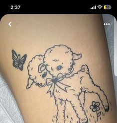 a tattoo on the leg of a woman with a teddy bear holding a flower and butterfly