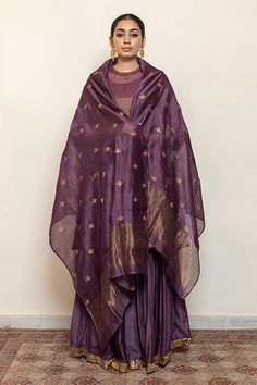 Aubergine kurta with embroidered floral and half moon motifs. Comes with an inner, matching gharara and chanderi silk dupatta.
Components: 4
Pattern: Embroidered
Type Of Work: Thread, Sequin
Neckline: Round
Sleeve Type: Three quarter
Fabric: Kurta: Chanderi Tissue, Gharara: Cotton Silk, Dupatta: Chanderi Silk, Lining: Cotton
Color: Purple
Other Details: 
Straight silhouette
Kurta side gathers
Occasion: Sangeet,Mehendi and Haldi - Aza Fashions Unstitched Purple Palazzo Set For Navratri, Purple Palazzo Set With Zari Work For Navratri, Bollywood Style Purple Palazzo Set With Dupatta, Purple Bollywood Palazzo Set With Dupatta, Bollywood Purple Palazzo Set For Diwali, Purple Sharara With Zari Work And Straight Kurta, Semi-stitched Purple Sharara With Resham Embroidery, Purple Raw Silk Salwar Kameez For Eid, Semi-stitched Purple Palazzo Set For Eid