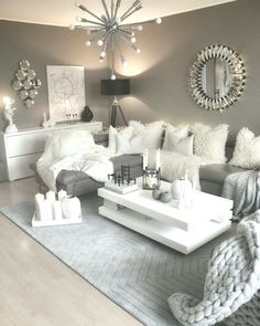 a living room filled with lots of white furniture