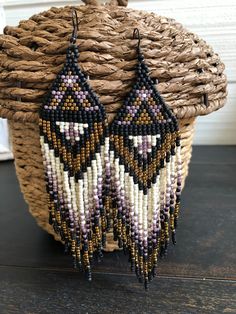 the beaded earrings are hanging from a basket