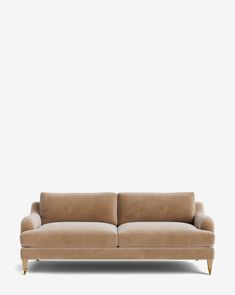 a tan couch against a white wall