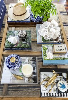 a table topped with plates and vases filled with plants