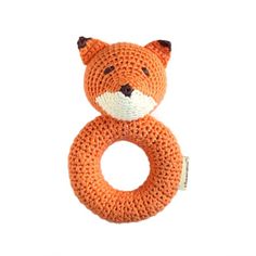 an orange knitted animal ring with a white background