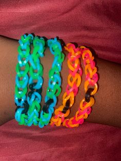 three different colored bracelets on someone's arm