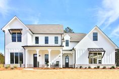 a white house with black shutters and windows