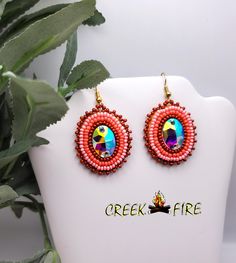 These are authentic Native American earrings, hand crafted by a member of the Muskogee Creek Tribe. Used in the handmade process are seed beads,  acrylic cabochons and faux leather backing. The bead colors included in this pair are: Rust, Peach and lt. Peach seed beads. They measure 1 inches wide and 2 inches long including the ear wire. They have gold plated ear wires for pierced ears. Muskogee Creek, Creek Tribe, Peach Seed, Peach Earrings, Native American Earrings, Pierced Ears, Ear Wires