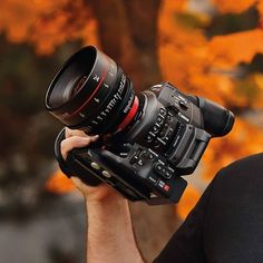 a man holding up a camera to take a photo with it's lens in front of his face