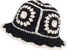 a black and white crocheted hat with flowers on the brimmings