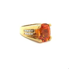 GIA Certified Unisex Ring in 18K Yellow Gold, weighing 14.90 grams, boasting a 13.5 carat oval cut Spessartine Garnet center stone. The vibrant orange gem is superbly clean and lustrous. Exploding with color and brilliance. Adorned with 16 princess cut diamond side stones, totaling 0.96 carats.  This Spessartine Garnet is extremely rare due to its rich Mandarine Orange color, lack of inclusions, and 13.5 carat size.   Item Details: - Type: Unisex Ring  - Metal: 18K Yellow Gold  - Weight: 14.90 Grams  - Setting: 4-Prong  - Size: 7.5 (adjustable) - Mounting: 17 MM elevation  ___________________________  Center Stone Details: - Type: Spessartine Garnet  - Carat: 13.5  - Cut: Oval-Brilliant - Color: Mandarine Orange  - Measurements: 14.24 x 10.75 x 8.08 MM   GIA Certificate #: 6234022072  GIA Oval Orange Ring With Center Stone, Classic Orange Oval Jewelry, Luxury Orange Oval Jewelry, Orange Oval Cabochon Jewelry For Formal Occasions, Formal Orange Oval Cabochon Jewelry, Modern Orange Oval Rings, Modern Orange Oval Jewelry, Orange Oval Center Stone Jewelry, Oval Orange Jewelry With Center Stone