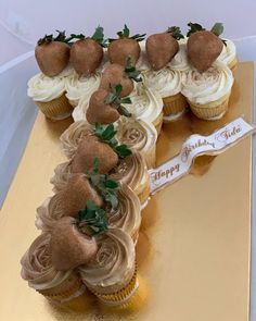 cupcakes are arranged in the shape of a letter f on a gold plate