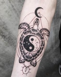 a black and white tattoo with a turtle on it's arm