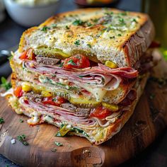 a cut in half sandwich sitting on top of a wooden cutting board