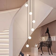 a staircase with lights hanging from it's sides and an animal statue on the floor