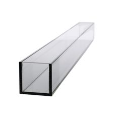 a clear glass shelf sitting on top of a white wall next to a black frame