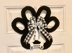 a black and white dog paw wreath on a door