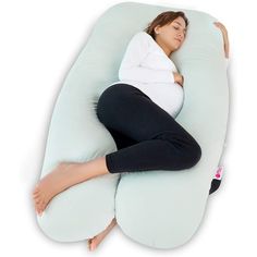 a pregnant woman is laying down on a pillow