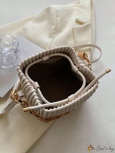 BirdinBag - Compact Pleated PU Mini Bucket Bag with Chain Embellishment Chic Rectangular Bucket Bag As Fashion Accessory, Beige Bucket Bag With Chain Strap, Beige Bucket Shoulder Bag With Chain Strap, Beige Shoulder Bucket Bag With Chain Strap, Trendy Cream Bag With Chain Strap, Gold Bucket Bag With Chain Strap, Rectangular Bucket Bag With Chain Strap, Everyday Bucket Bag With Chain, Bucket Shoulder Bag With Chain Strap