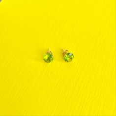 Light up the room with beautiful peridot. Symbolizing confidence and leadership, these olive-green, 14k solid gold earrings are a gorgeous complement to your inner beauty. DETAILS:Diameter: 6mmMaterial: 14k yellow goldStones: Peridot Cubic ZirconiaClosure: Push Back Green Peridot Earrings For Anniversary, Classic Green Peridot Earrings, Minimalist Green Earrings For Anniversary, Green Minimalist Earrings For Anniversary, Green 14k Gold Birthstone Earrings, 14k Gold Green Birthstone Earrings, Green 14k Gold Hypoallergenic Earrings, Hypoallergenic 14k Gold Green Earrings, Solid Gold Earrings