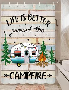 a shower curtain with the words life is better around the campfire