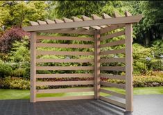 an open wooden gate in the middle of a garden