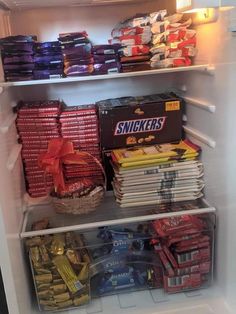 an open refrigerator filled with lots of food and snacks in it's door,