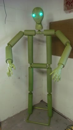 a green robot with glowing eyes and arms